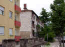 Typický paradox současné Bosny - rozstřílený dům vedle nové zástavby - Mostar